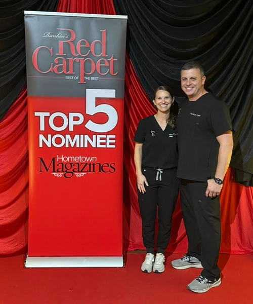 Chad Moore And Alecia Moore In Front Of Award